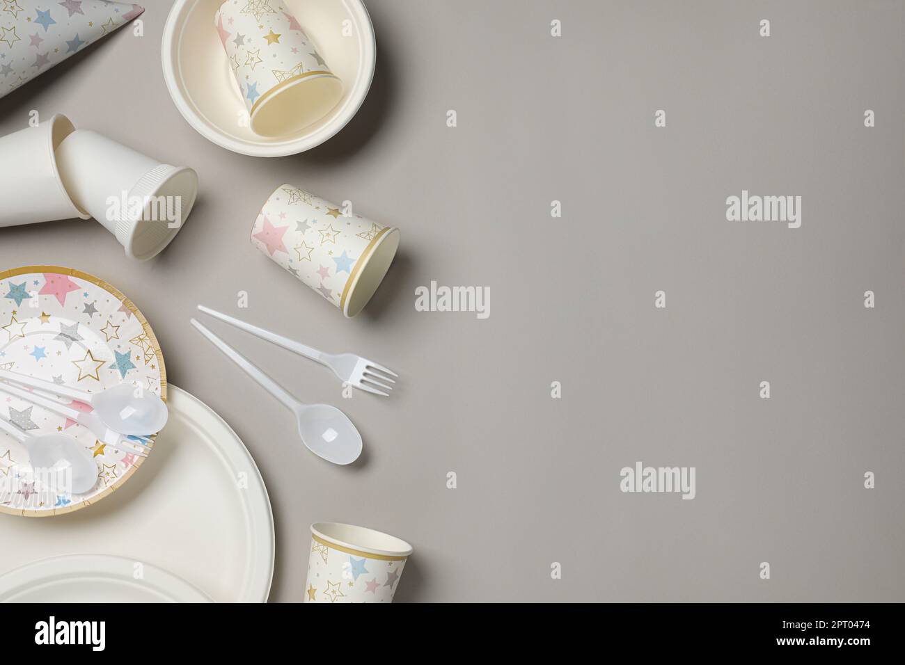Disposable tableware on light grey background, flat lay. Space for text ...