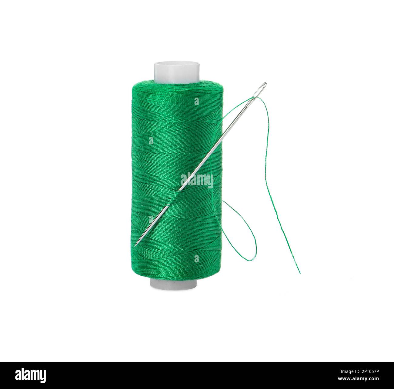 Spool of green sewing thread with needle isolated on white Stock Photo Alamy