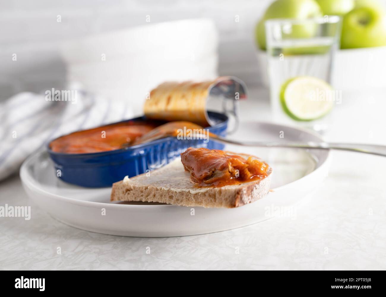 Canned herring in tomato sauce on a slice of bread Stock Photo Alamy