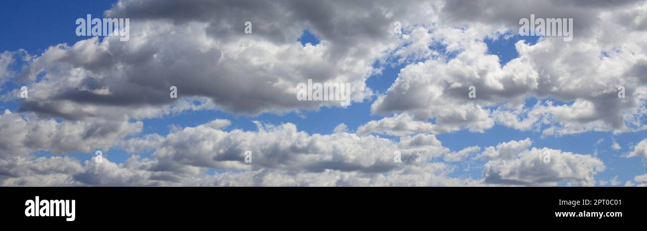 A blue sky with lots of white clouds of different sizes Stock Photo - Alamy