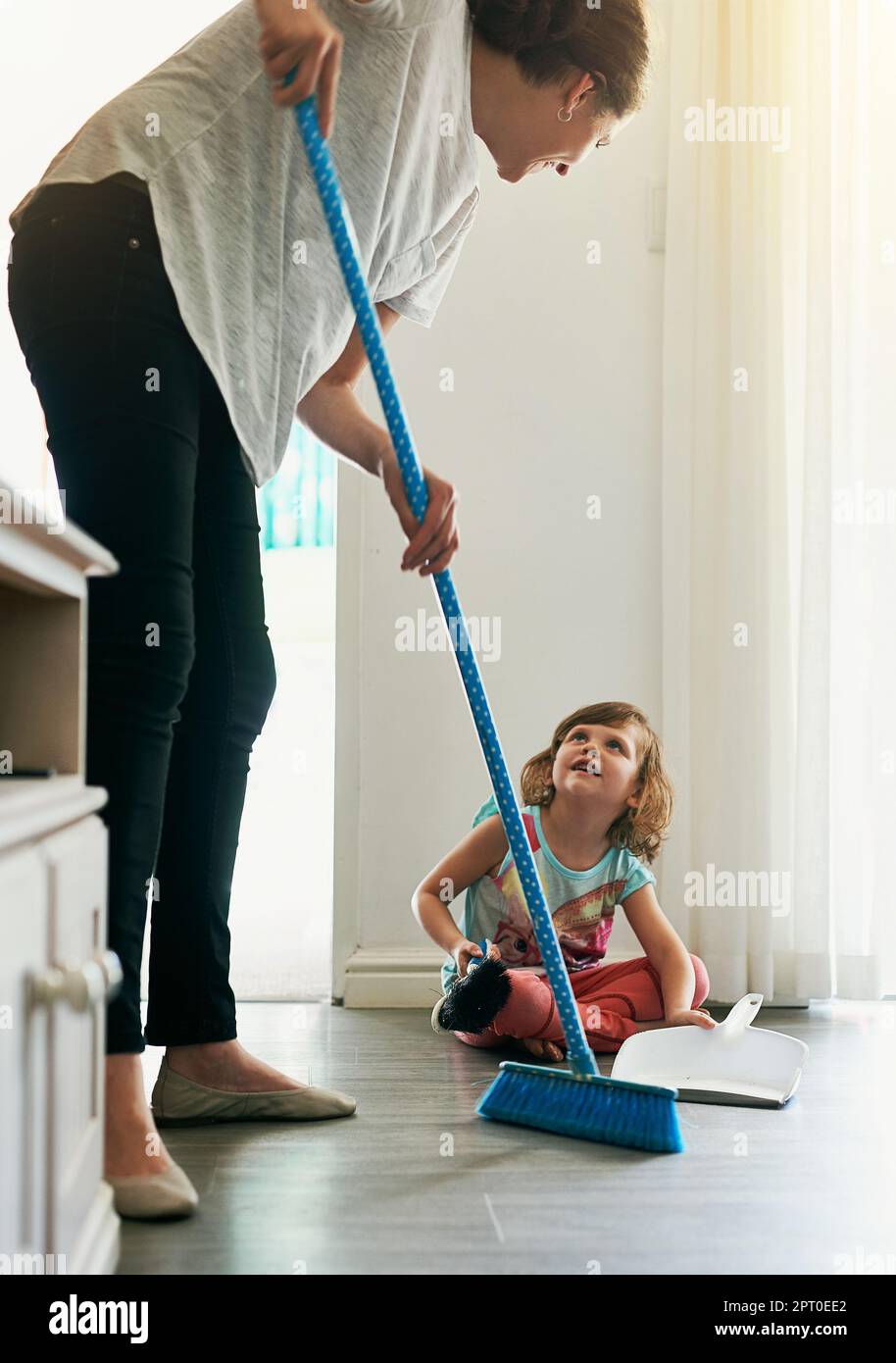 Shes such a help around the house. a mother and daughter sweeping the floor together Stock Photo