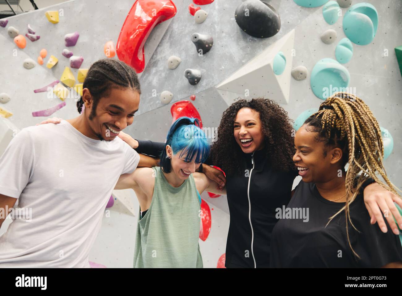 Group Of Friends Having Fun Trying Indoor Climbing Wall At Indoor ...