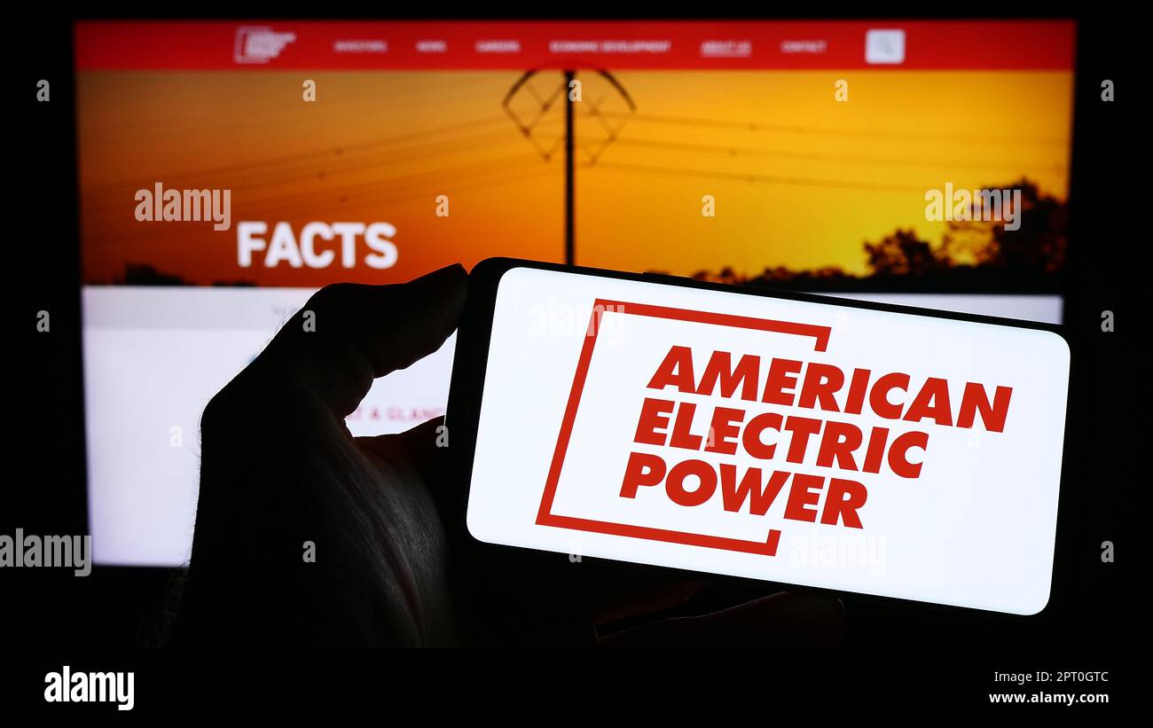 Person holding smartphone with logo of American Electric Power Company
