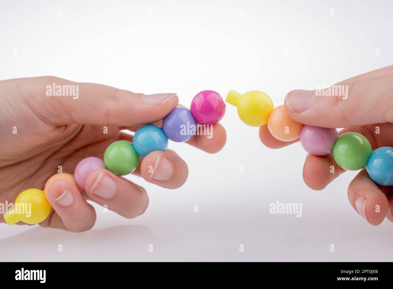 Hand holding Color beads with facial expression on white background Stock Photo