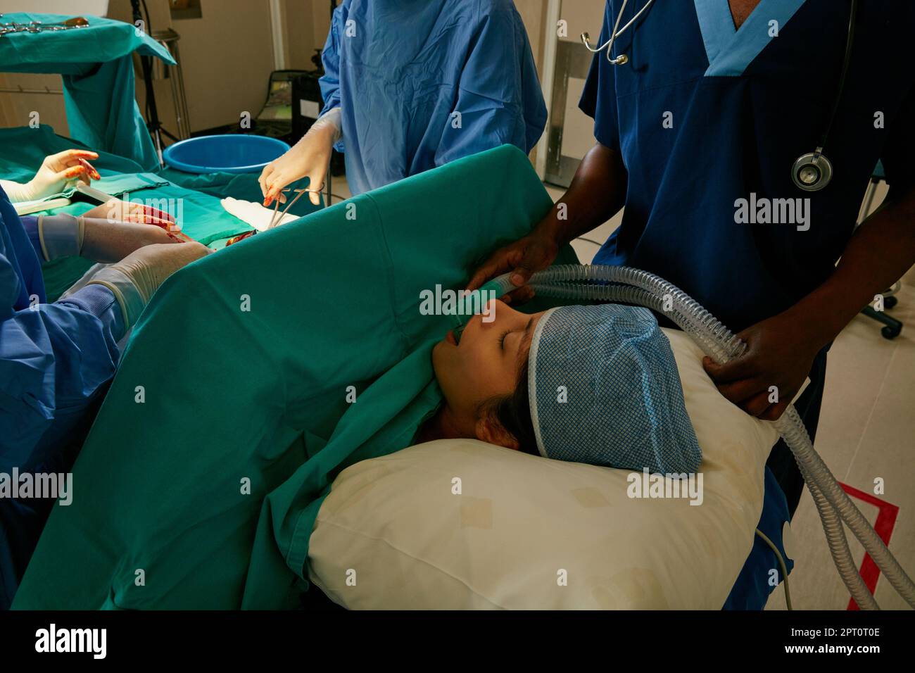Working together to make her better. a team of surgeons performing a ...