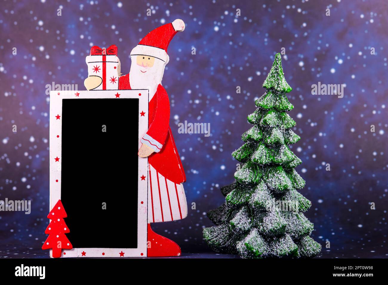 Santa Claus with empty blackboard and snowy fir tree Stock Photo - Alamy