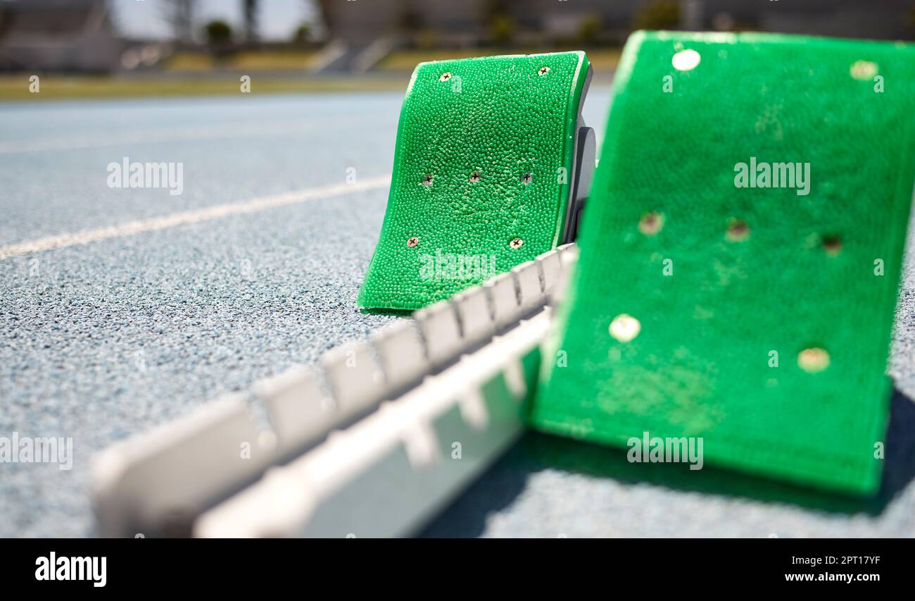 Sports closeup, starting blocks and running track, field or pitch for