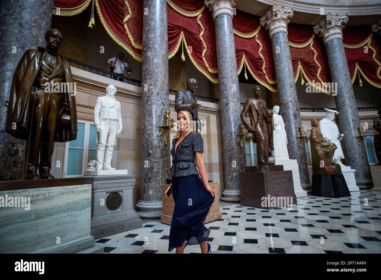 Paris Hilton stops to pose for photographers in Statuary Hall during a
