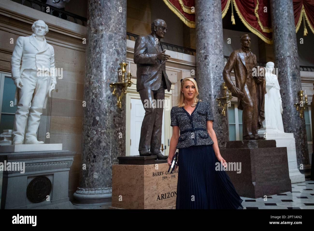 Paris Hilton stops to pose for photographers in Statuary Hall during a