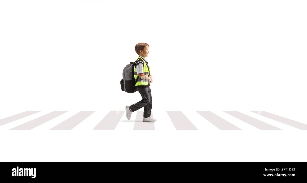Full length profile shot of a schoolboy wearing a reflective vest and