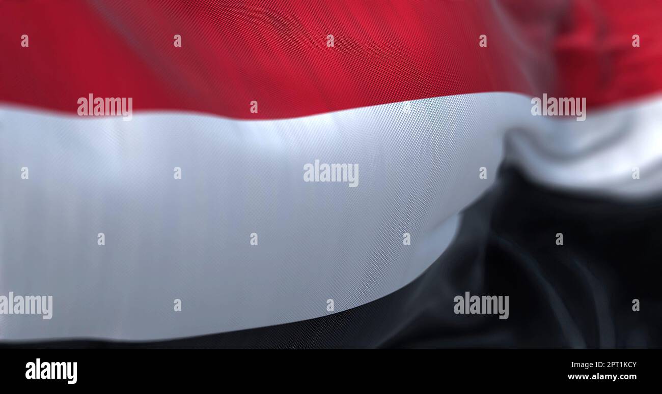 Close-up view of the Yemen national flag waving. The Republic of Yemen is a state located in Western Asia. Fabric textured background. Selective focus Stock Photo