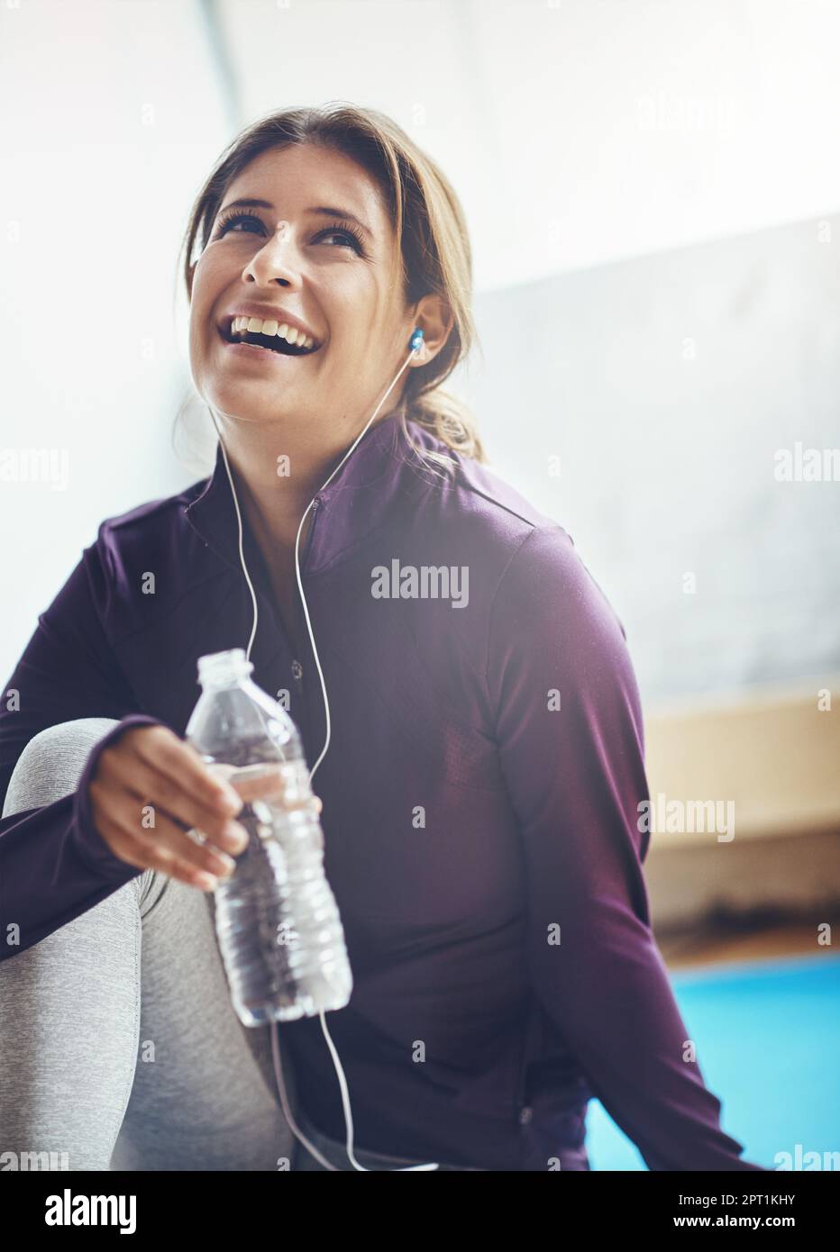 Now thats refreshing. an attractive young woman drinking water while