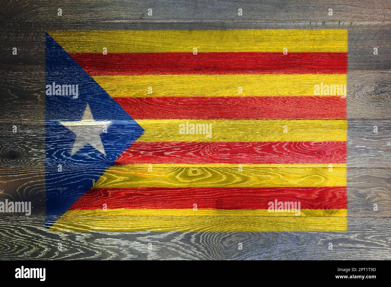 A Catalonia independence flag on rustic old wood surface background red yellow blue white star Estelada Stock Photo