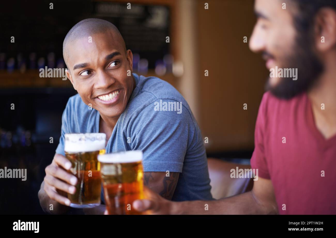 Cheers mate. A cropped shot of young friends having drinks in a bar