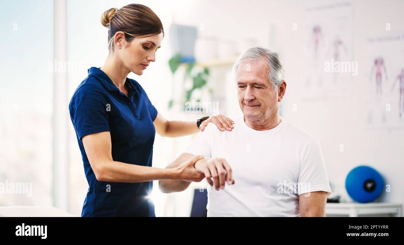 Nurse, patient and physical therapy for elderly care, medical or healthcare support at the clinic. Woman physiotherapist or chiropractor helping matur Stock Photo