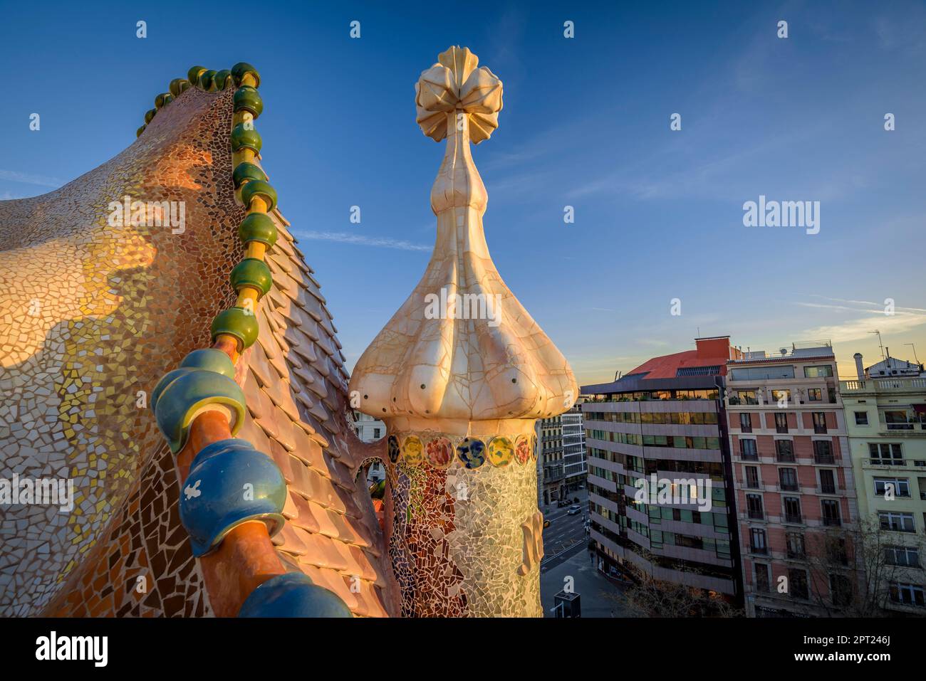 Roof of Casa Batlló with the shape of dragon scales and the cross of Sant Jordi (Saint George) at sunrise (Barcelona, Catalonia, Spain) Stock Photo