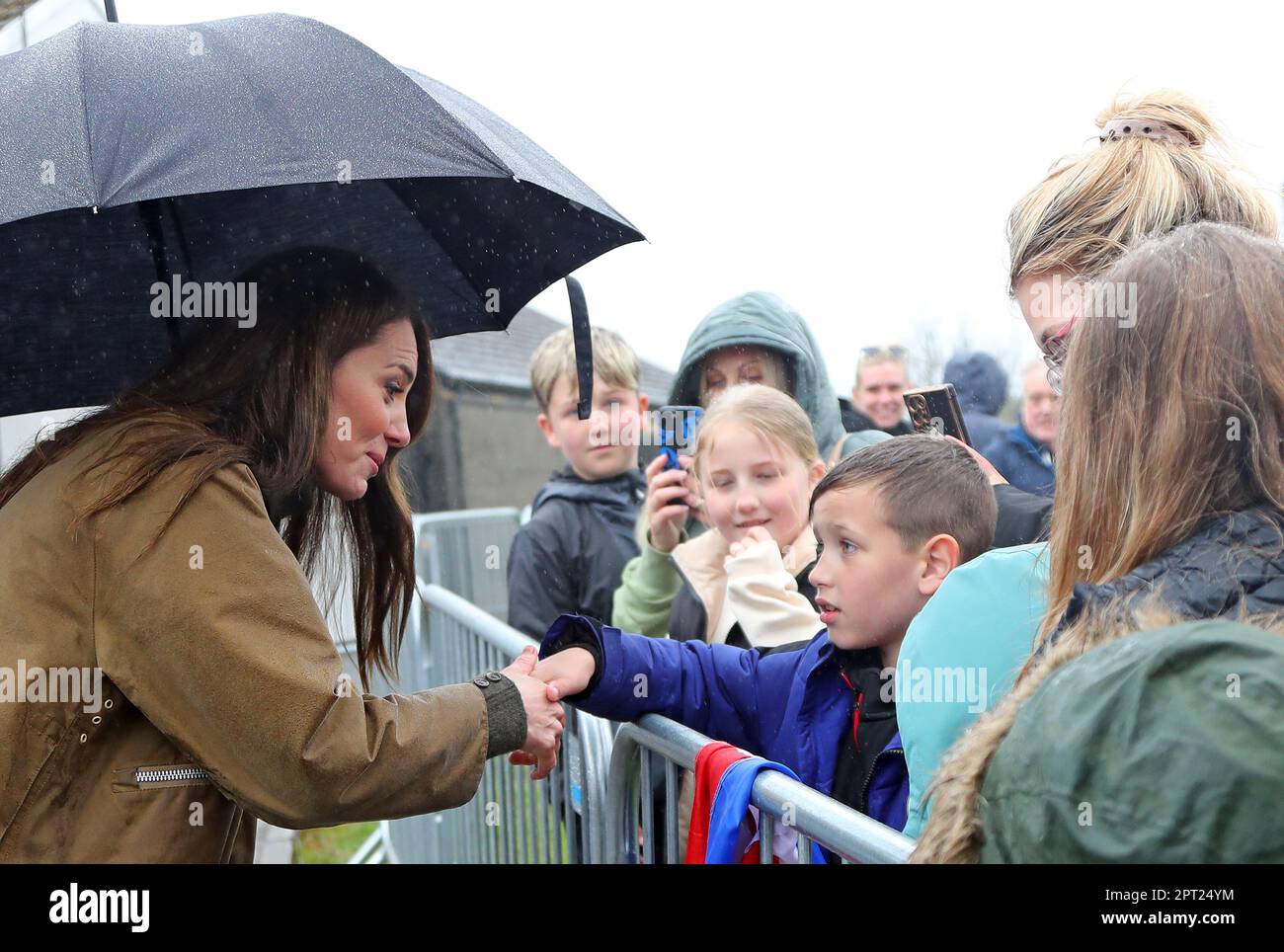 The Princess of Wales shakes hands with a young well wisher during a visit to Dowlais Rugby Club, near Merthyr Tydfil in Wales. The volunteer-run organisation, which covers the central area of the Bannau Brycheiniog National Park including Pen y Fan, is celebrating its 60th birthday. Picture date: Thursday April 27, 2023. Stock Photo