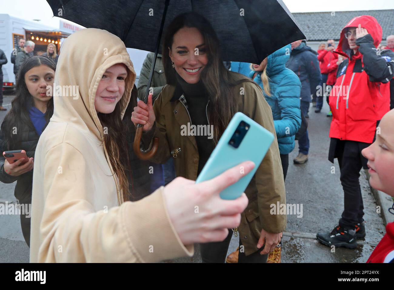The Princess of Wales poses for a selfie photograph with a young well wisher during a visit to Dowlais Rugby Club, near Merthyr Tydfil in Wales. The volunteer-run organisation, which covers the central area of the Bannau Brycheiniog National Park including Pen y Fan, is celebrating its 60th birthday. Picture date: Thursday April 27, 2023. Stock Photo