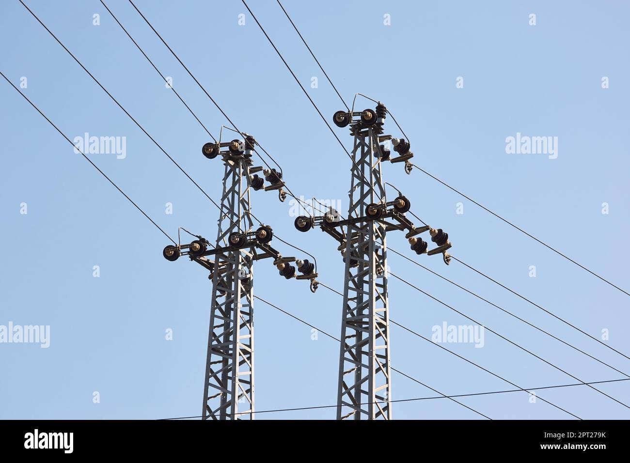 Electric lines overhaead, power line against blue sky Stock Photo - Alamy