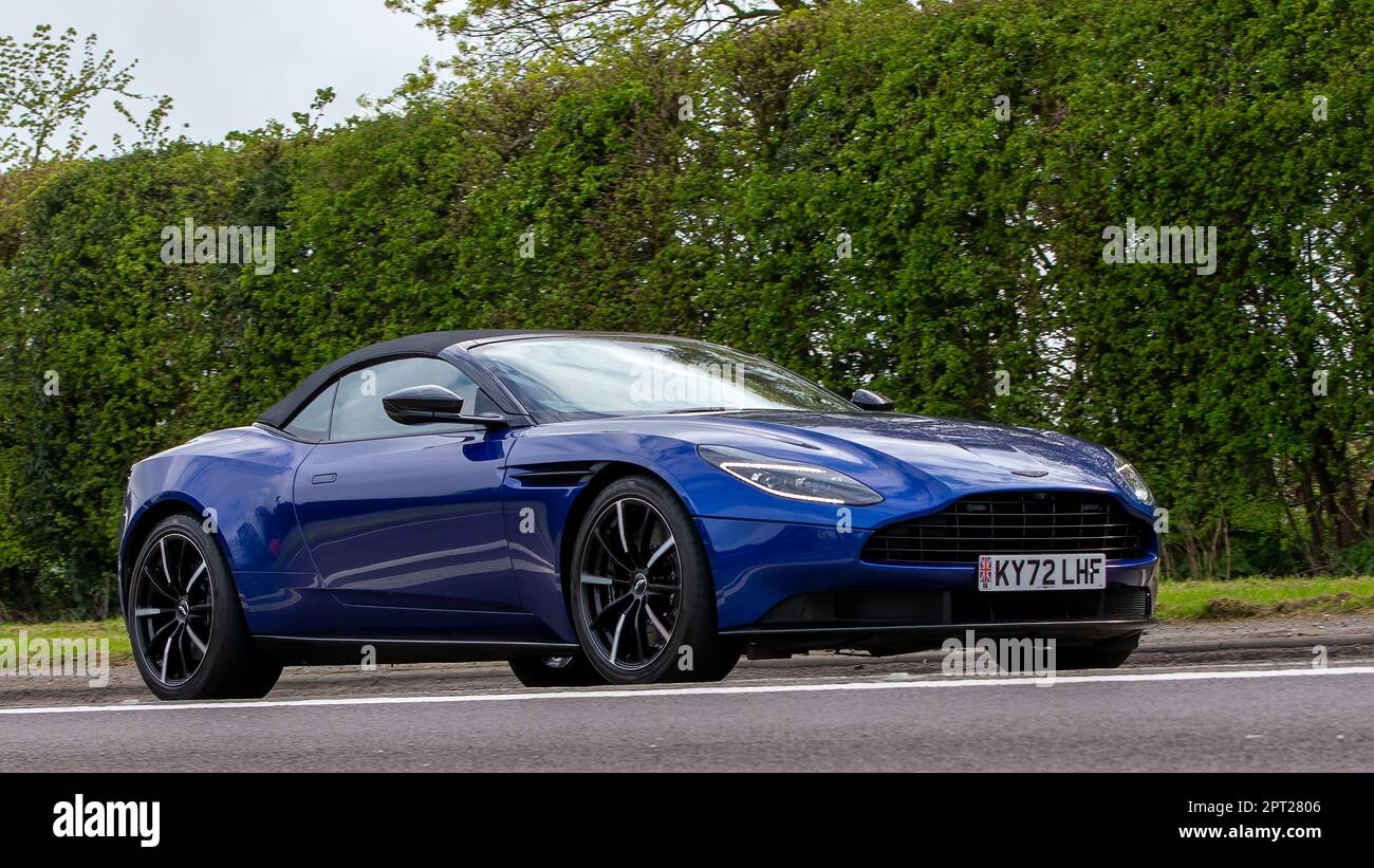 Bicester,Oxon,UK - April 23rd 2023.2022 blue ASTON MARTIN DB11  car travelling on an English country road Stock Photo