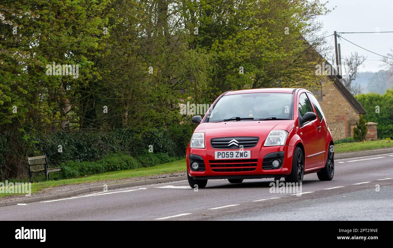 Bicester,Oxon,UK - April 23rd 2023. 2009 red CITROEN C2   travelling on an English country road Stock Photo
