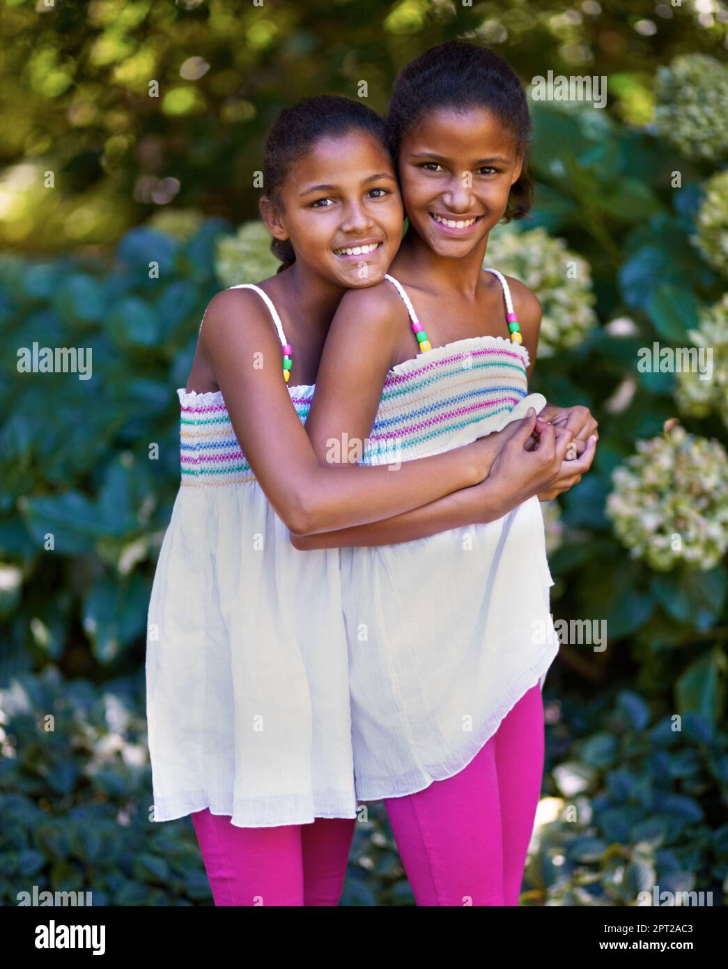 Its great having a twin. Portrait of two twin sisters standing together