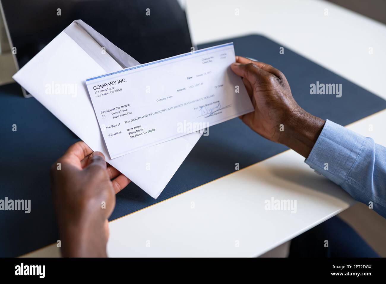 American African Holding Paycheck Or Payroll Check Stock Photo