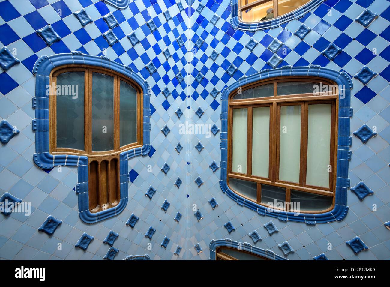 Inner courtyard of Casa Batlló decorated with a gradient mosaic from blue to white designed by Gaudí (Barcelona, Catalonia, Spain) Stock Photo