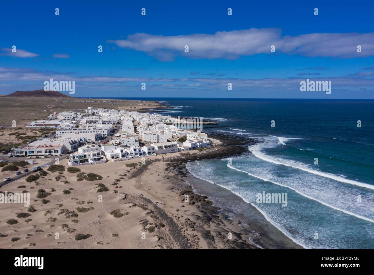 Landscape panorama of La Caleta de Famara and fire mountain, Lanzarote, Lanzarote, the Canary islands, Spain Stock Photo