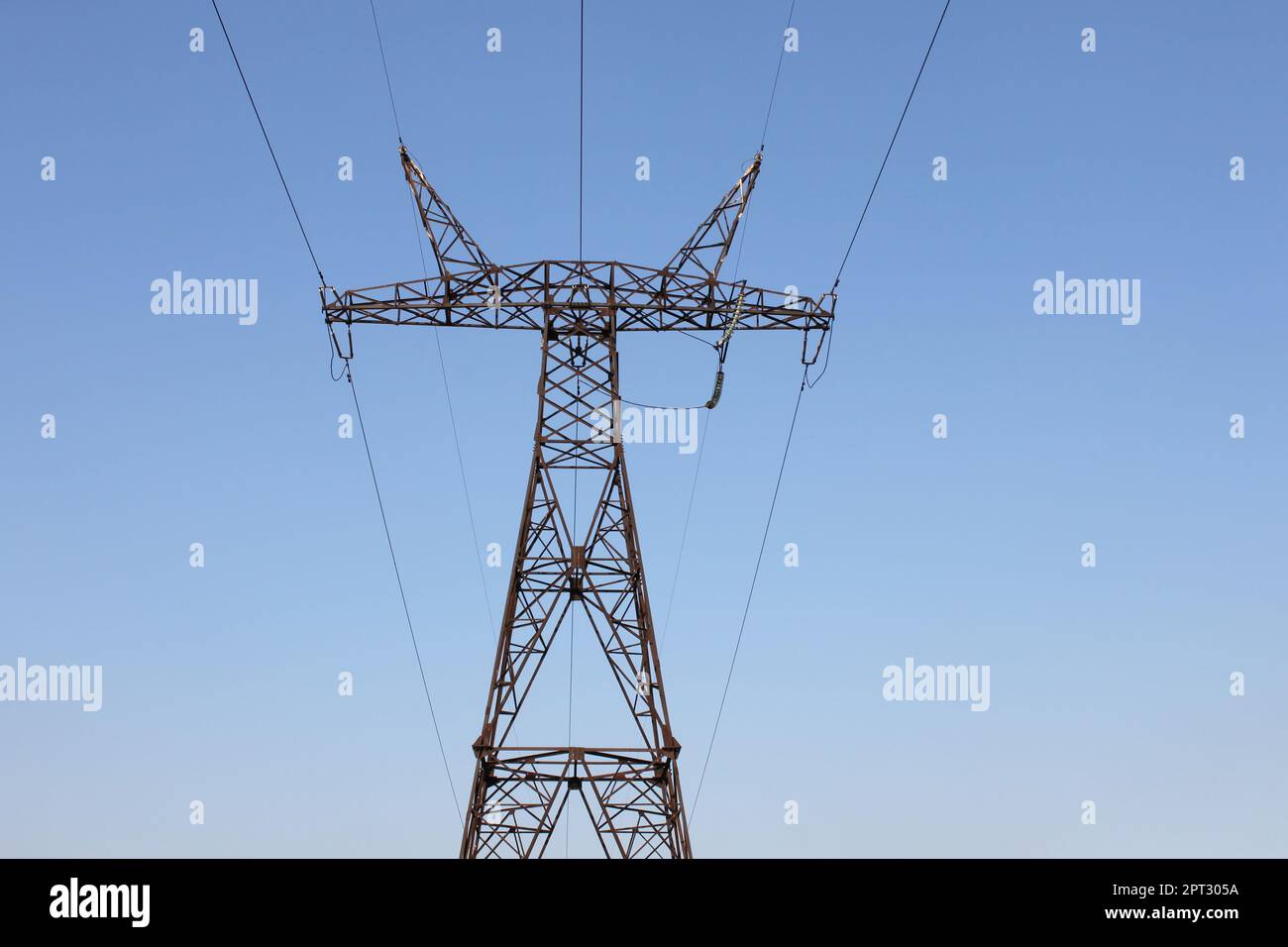 view on electricity pylon against blue sky in Ukraine Stock Photo