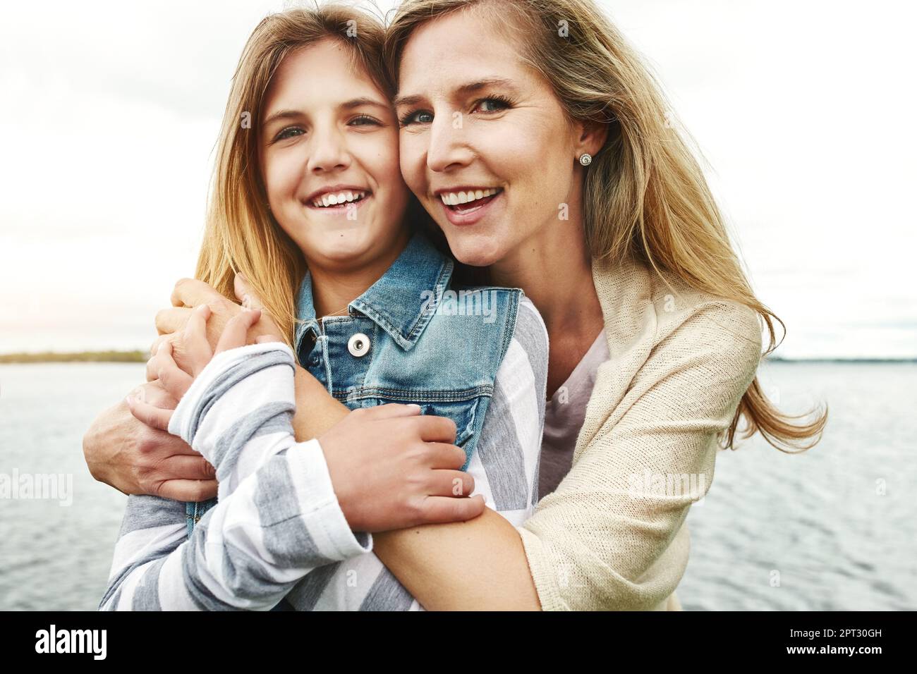 Filling each others lives with the biggest smiles. Portrait of a mother and her daughter bonding outdoors. Stock Photo