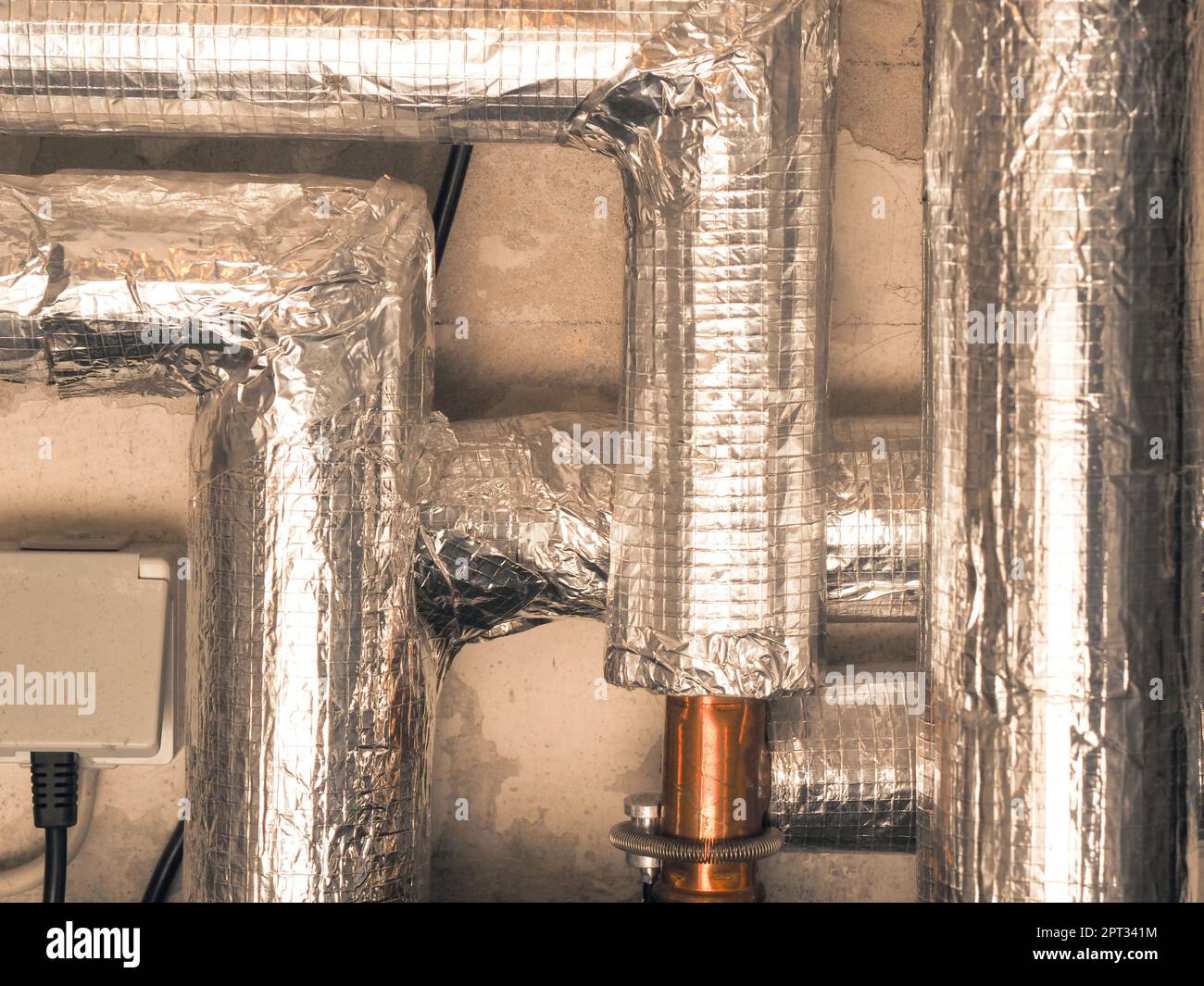 Heating pipes insulated with rock wool in a boiler room. Energy saving