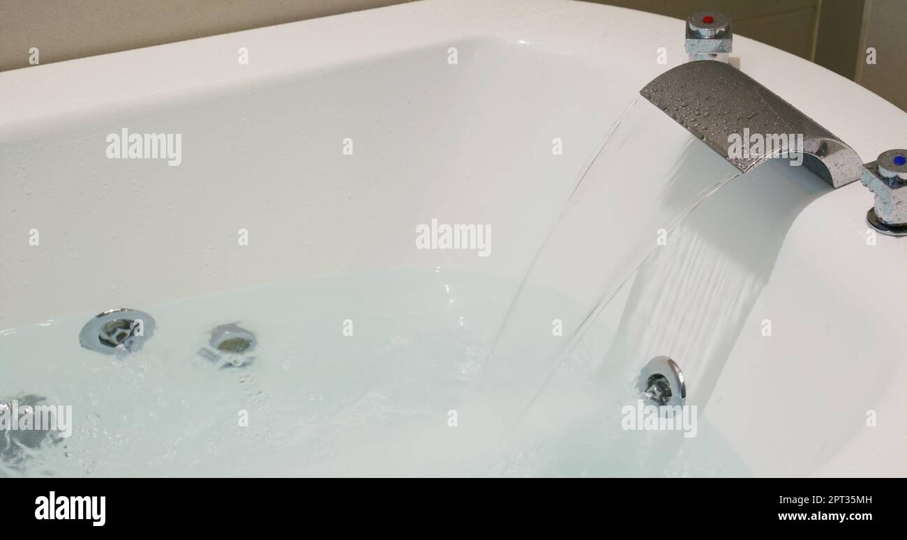 Water coming out from tap for the bathtub Stock Photo - Alamy