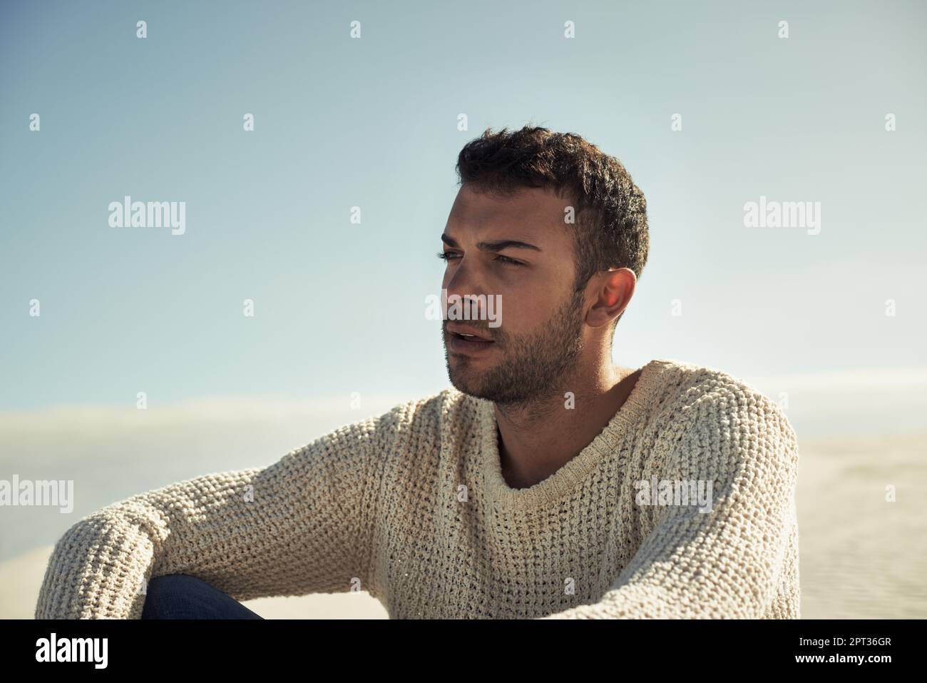 Desert masculinity. A ruggedly handsome young man enjoying the beach ...