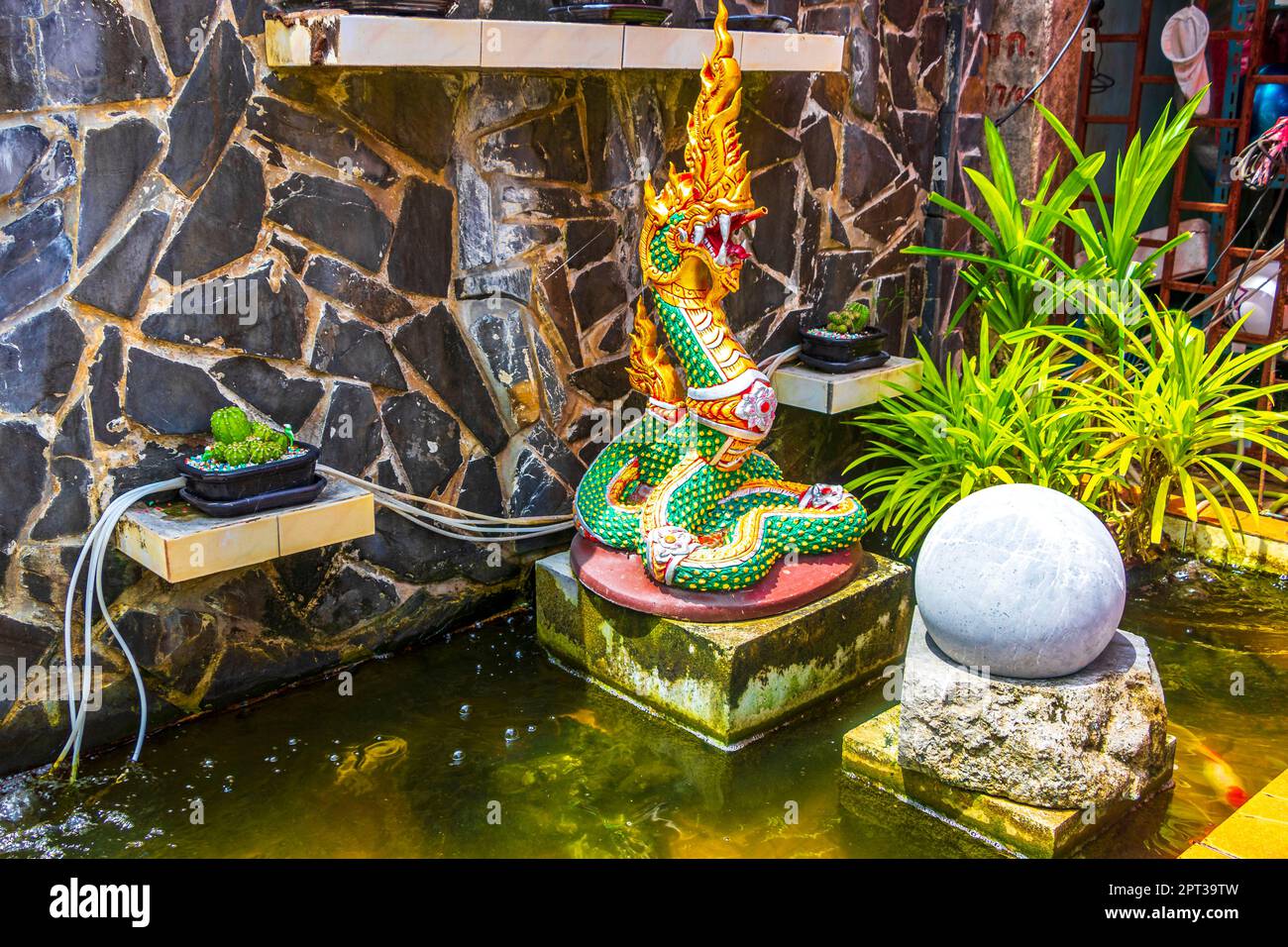 Asian thai artistic water fountain with dragons and snakes in Naithon Beach Sakhu Thalang on Phuket island Thailand in Southeastasia Asia. Stock Photo