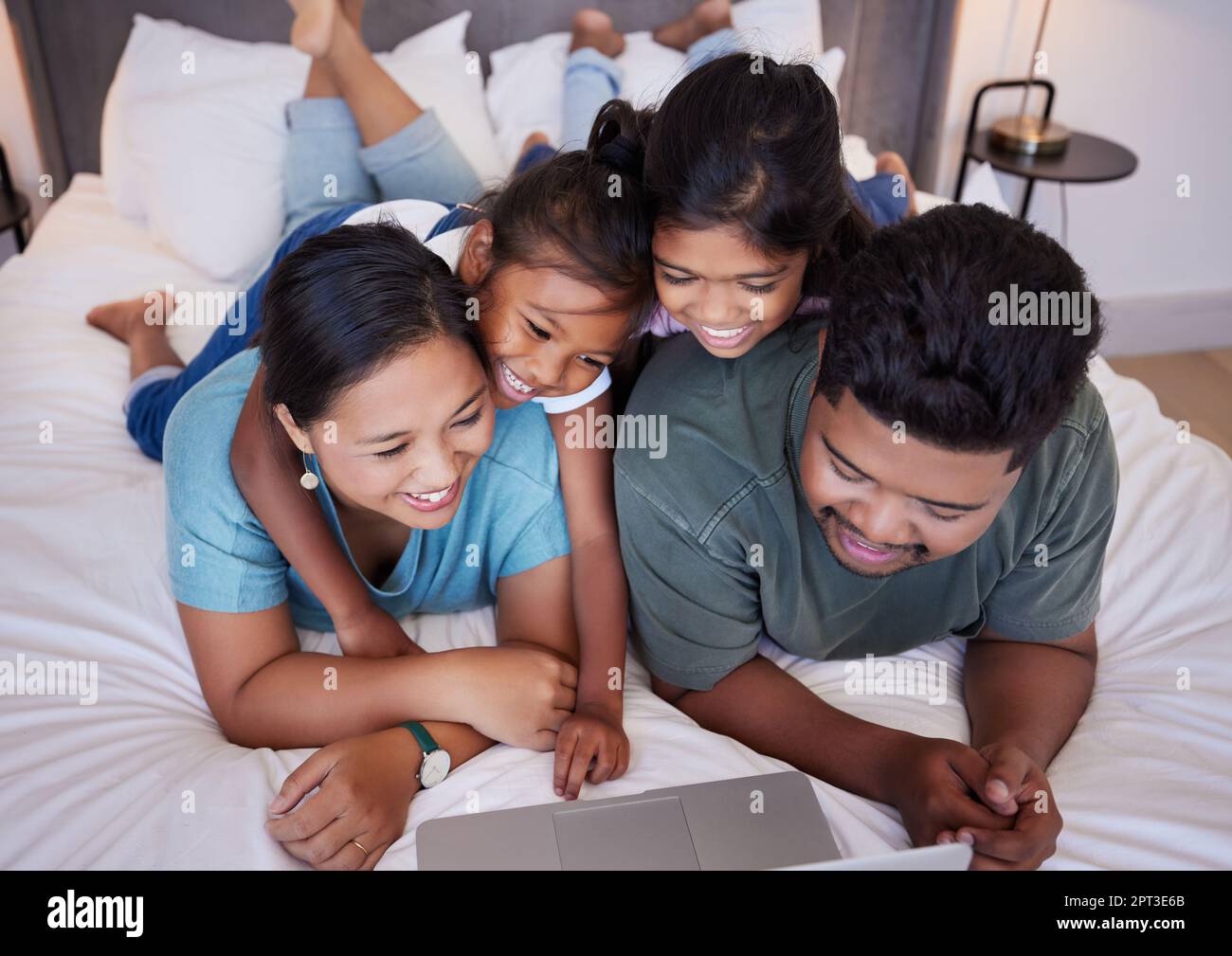 Happy, laptop and relax family in bed streaming subscription comedy movie, funny  video or online meme. Love, home bedroom and bonding mom, dad and chi Stock  Photo - Alamy