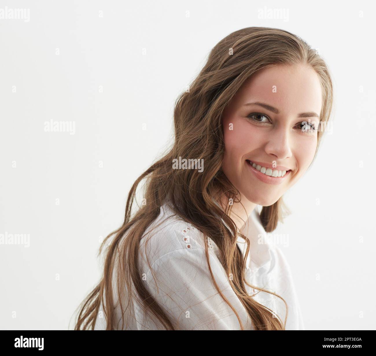 Just a little look back...Studio shot of a young woman looking over her