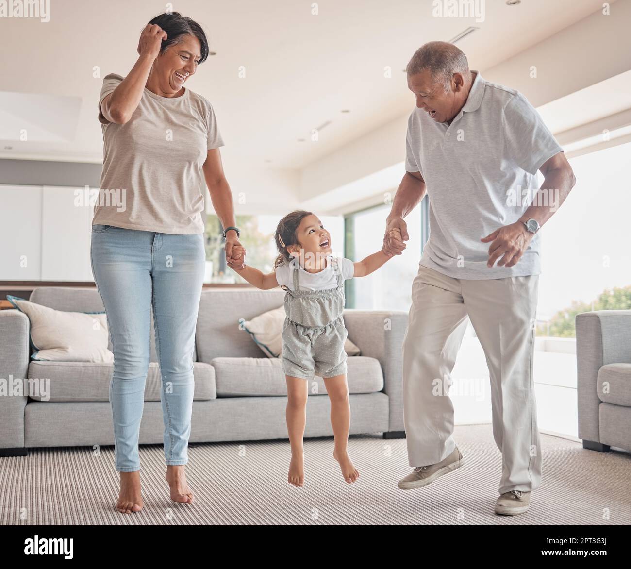 Mexico grandparents with child jump in living room home for fitness