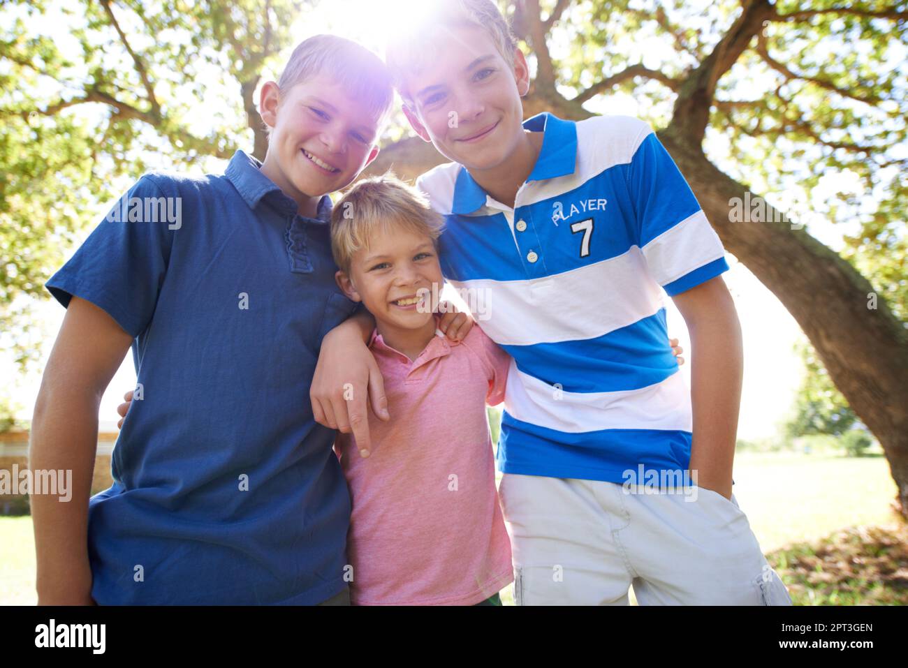 Spending time with his big brothers. Three brothers hugging one another