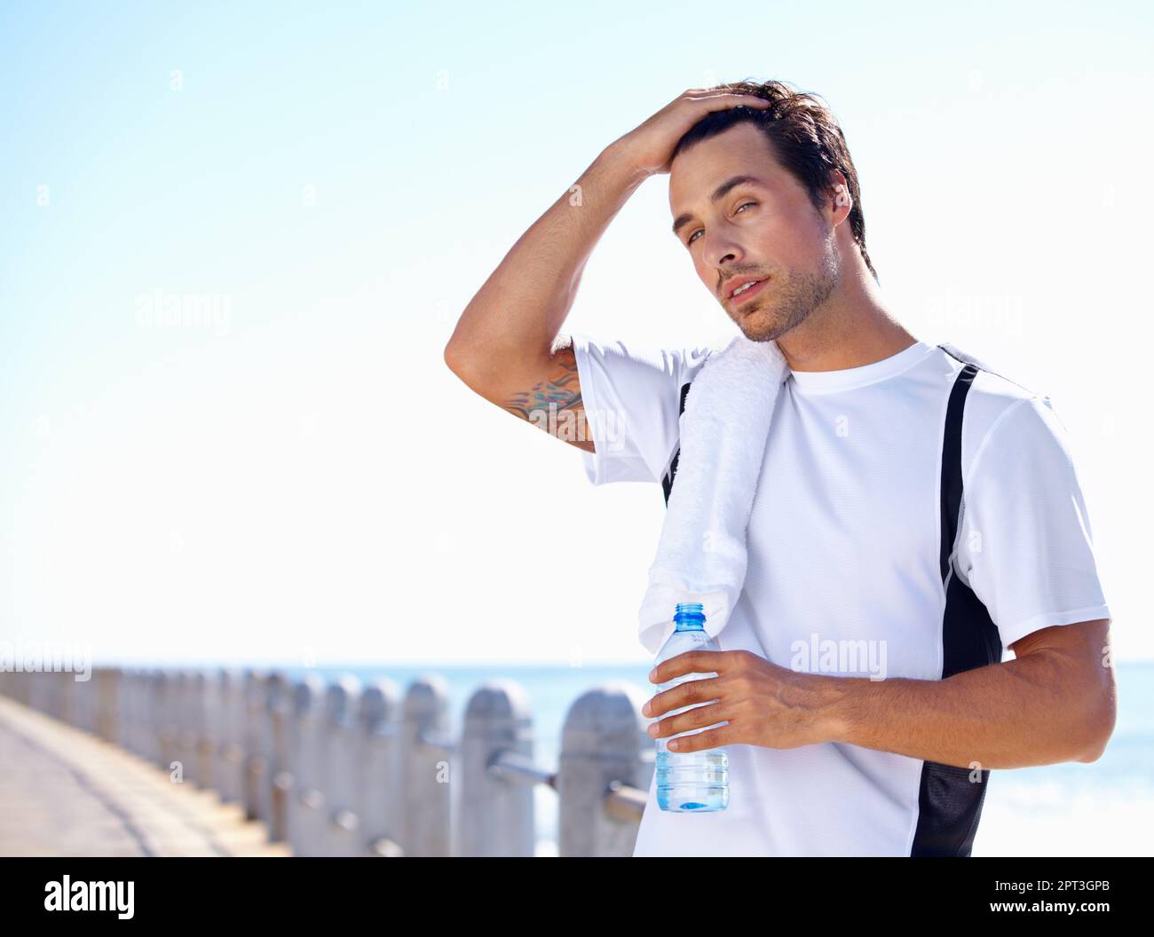 Taking a break. A young man taking a water break while exercising