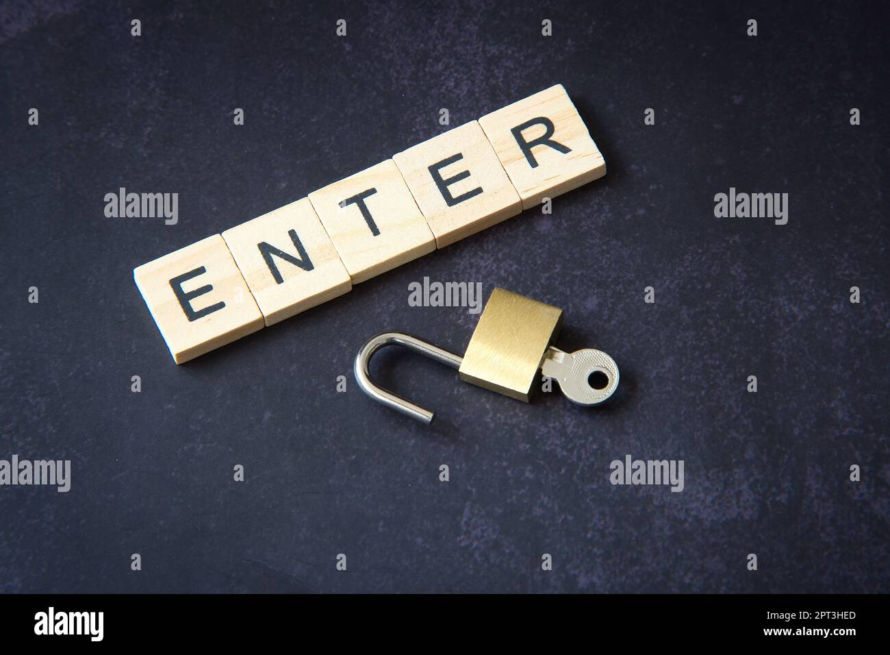 Word "enter" written in wooden letters next to a padlock representing