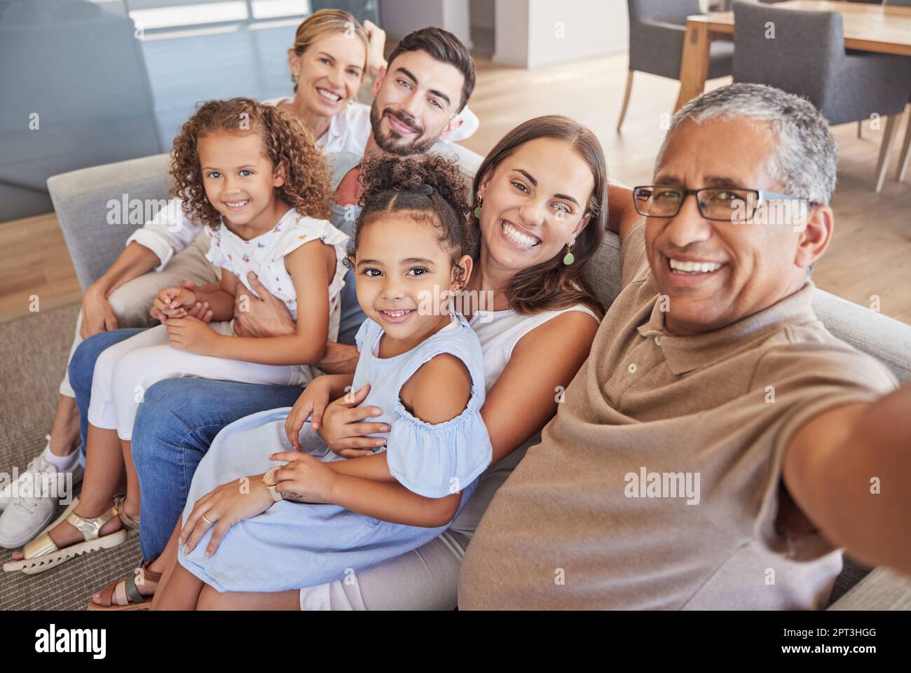 Selfie, family and children with a grandfather taking a photograph of his grandchildren and parents at home. Kids, love and grandparents with a man an Stock Photo