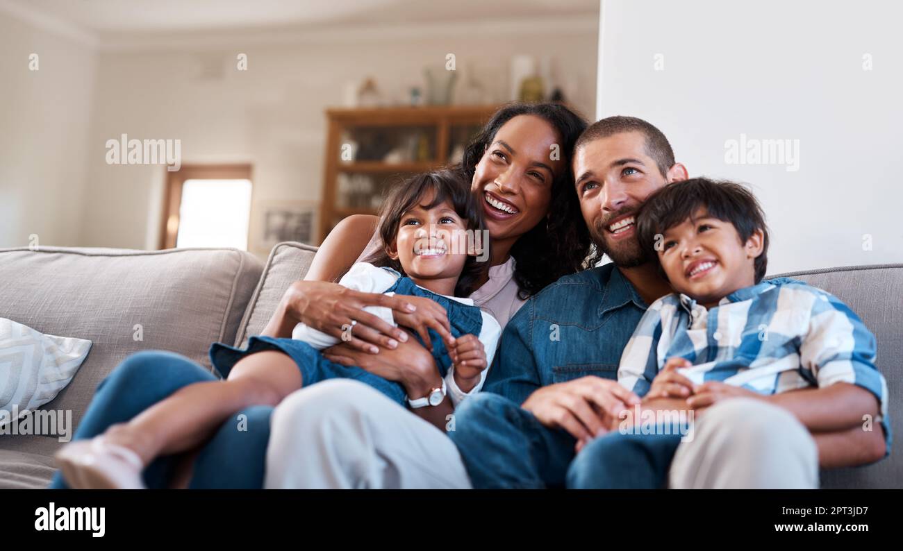 Keeping the family happy is what matters most. a family of four sitting ...