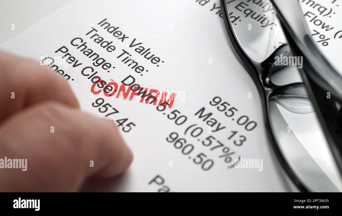 Finger tapping on financial report Stock Photo Alamy