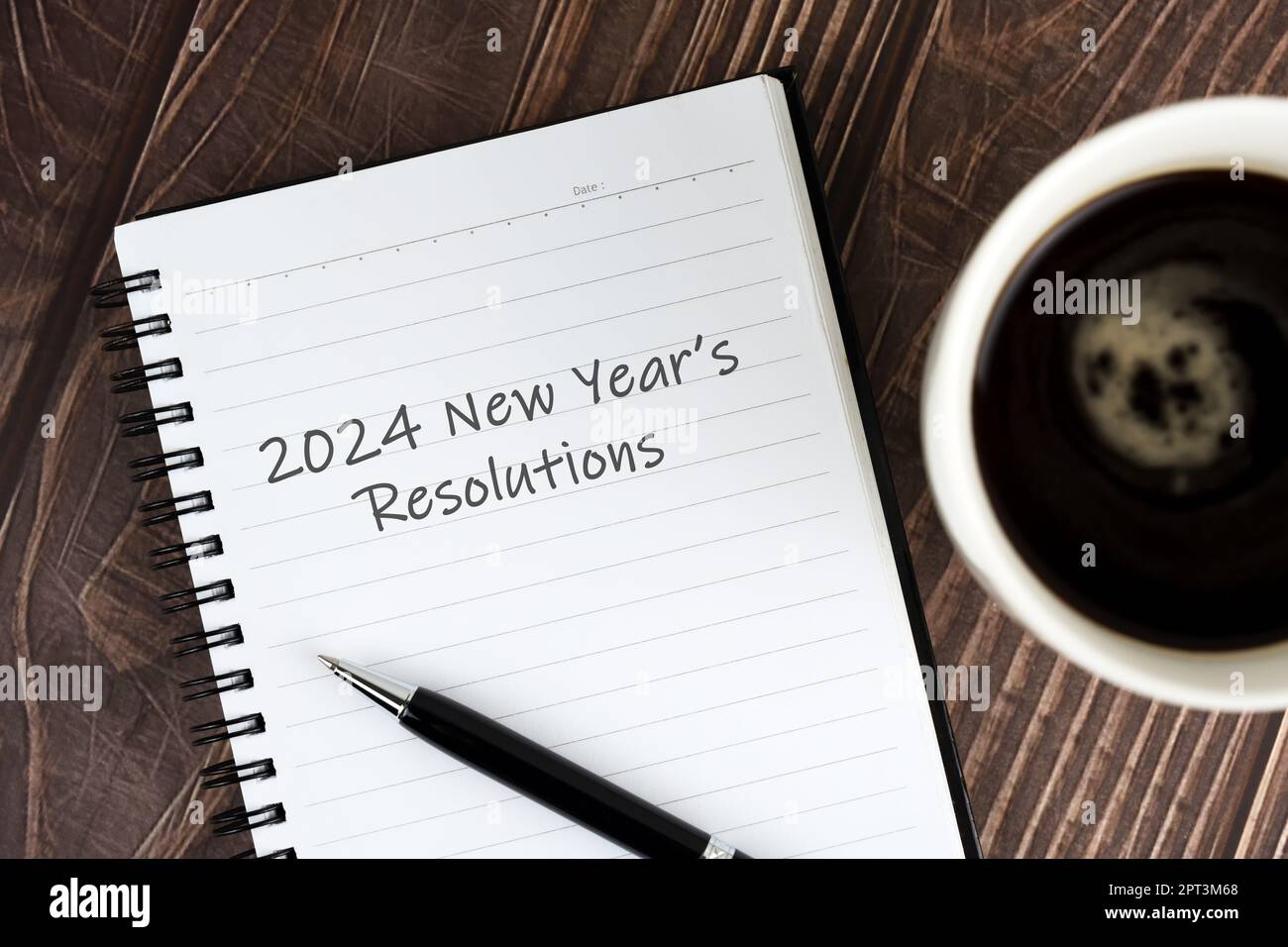 Cup Of Coffee And Notepad With Text 2024 New Years Resolutions Stock