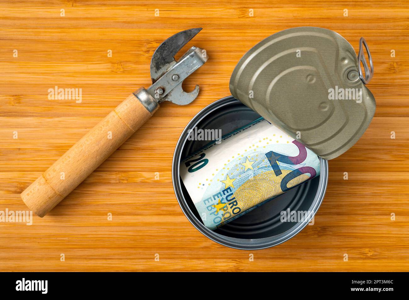 Can opener and tin box with a twenty Euros banknote. Financial savings