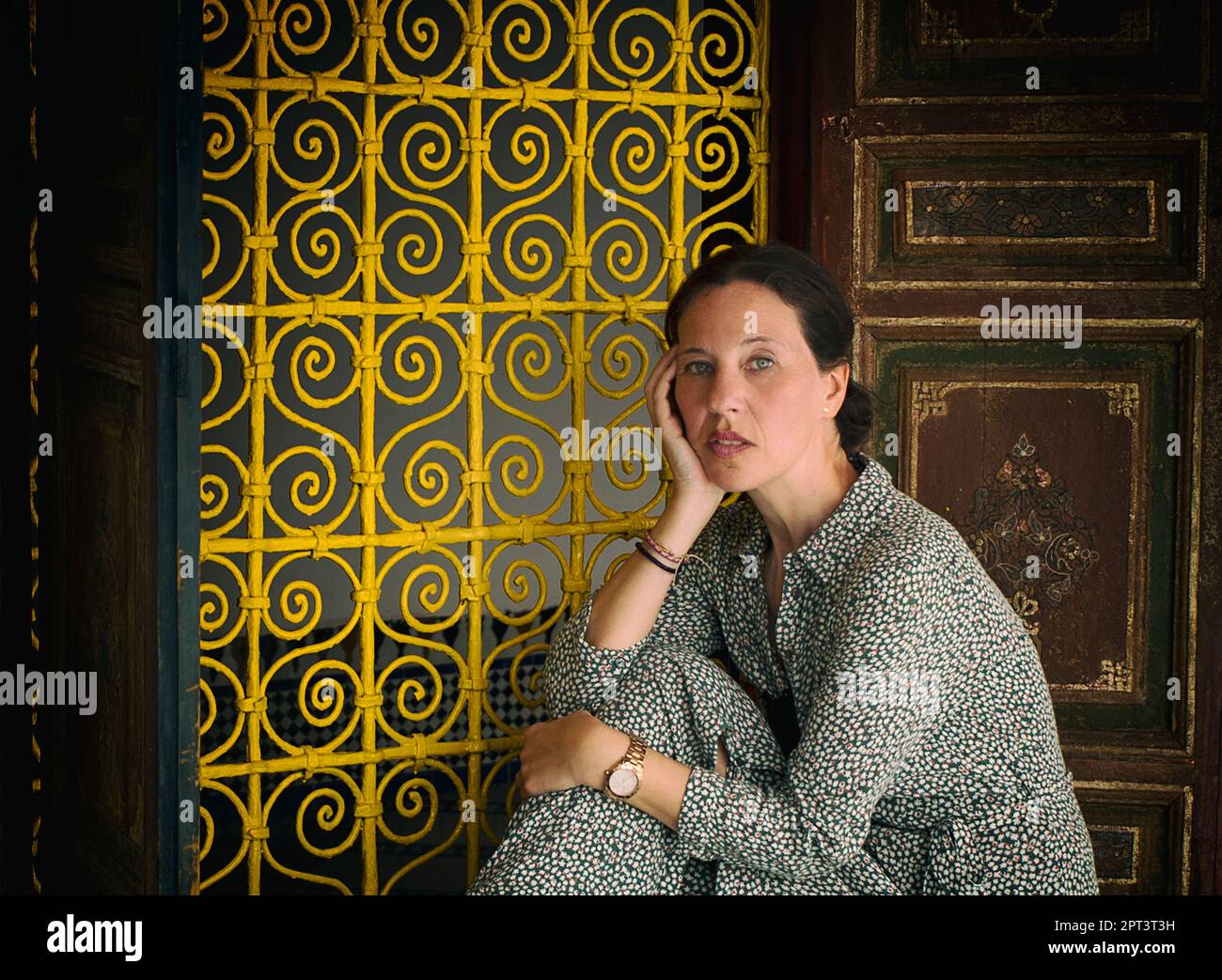 woman leaning against a moroccan style window, marrakech Stock Photo