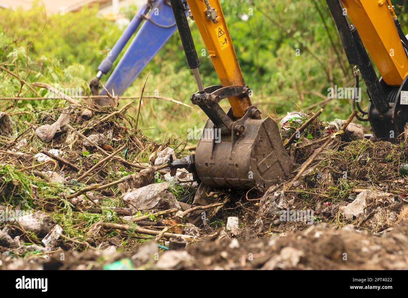 Backhoe digging soil at construction site. Bucket of backhoe digging