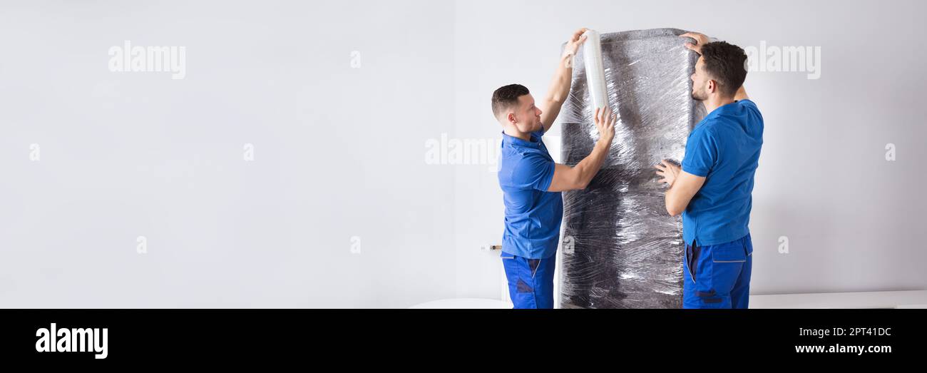 Professional Furniture Movers Wrapping. House Packing Service Stock