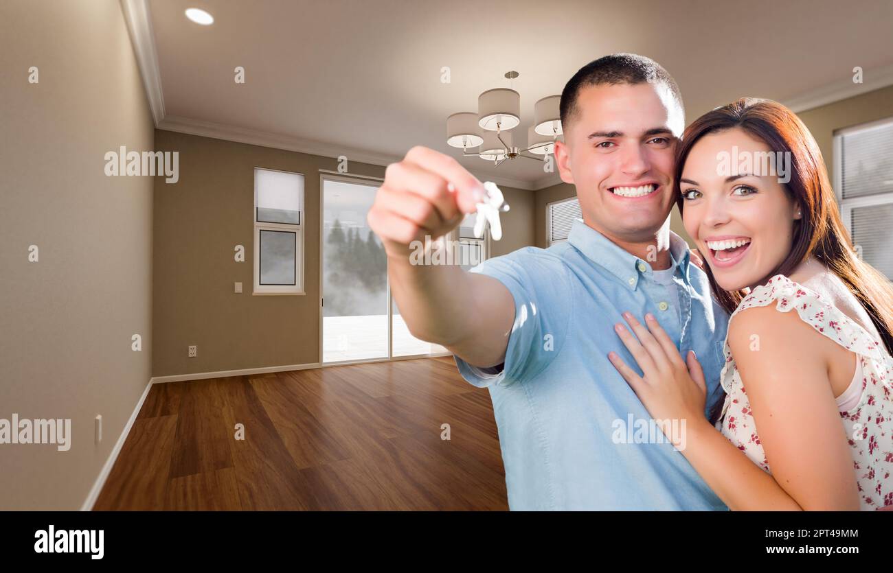 Young Military Couple with House Keys In Empty Room of New Home Stock ...